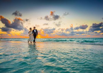 Man and Woman Walking of Body of Water