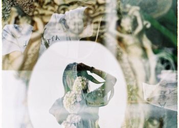 Reflection of Woman and Flowers in Window