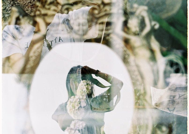 Reflection of Woman and Flowers in Window
