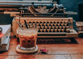 Cold Coffee in Glass Near Typewriter