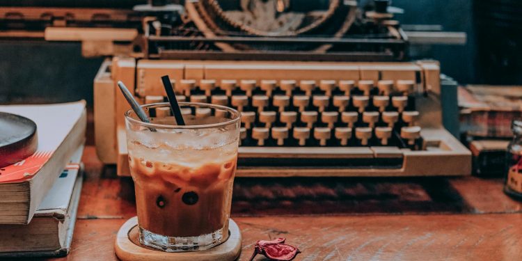 Cold Coffee in Glass Near Typewriter