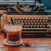 Cold Coffee in Glass Near Typewriter