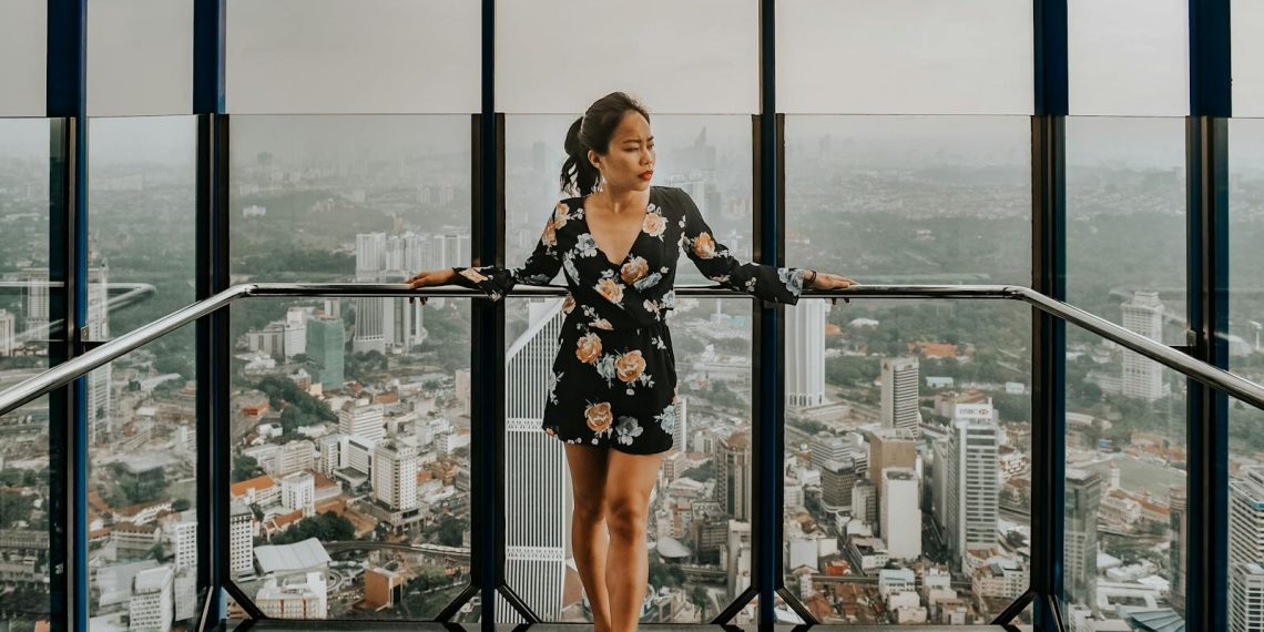 Woman Standing Against Railing