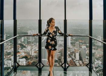 Woman Standing Against Railing