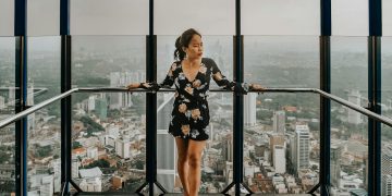Woman Standing Against Railing