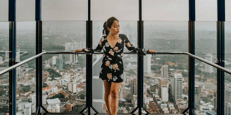 Woman Standing Against Railing