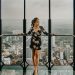 Woman Standing Against Railing