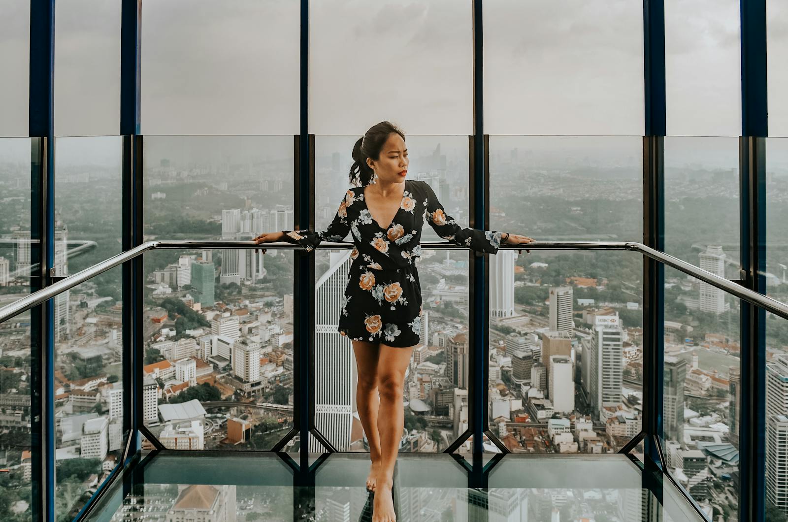 Woman Standing Against Railing