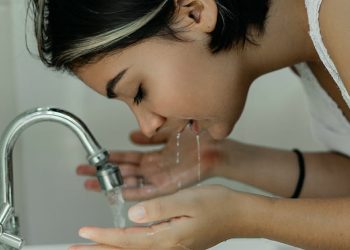 Woman Washing Her Face With Water