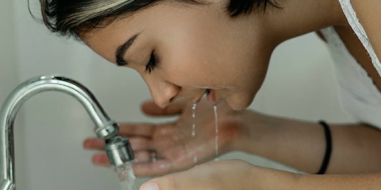 Woman Washing Her Face With Water
