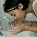 Woman Washing Her Face With Water