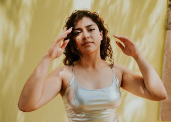 A woman in a silver top and silver pants