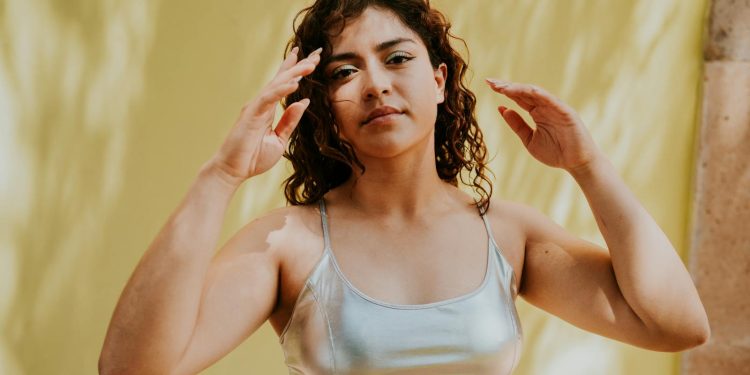 A woman in a silver top and silver pants