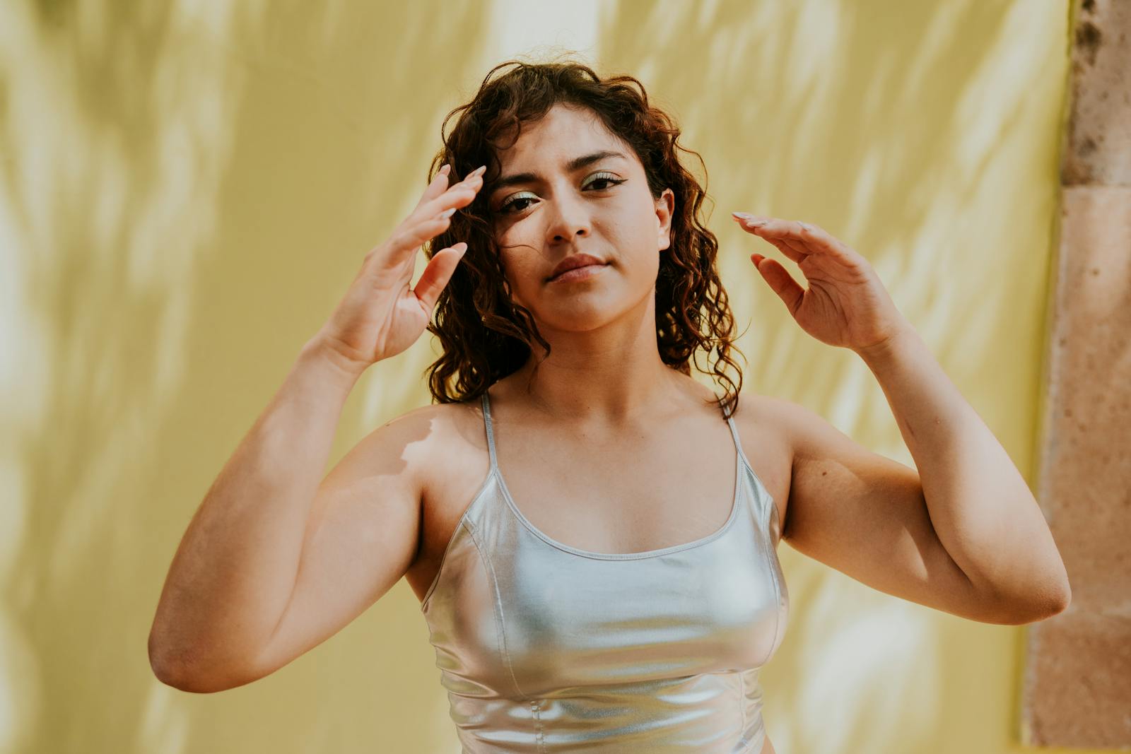 A woman in a silver top and silver pants