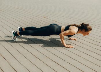 Woman in Black Tank Top and Black Leggings Doing Yoga