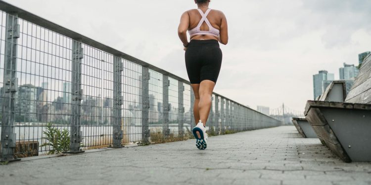 Woman in Sports Clothing Jogging