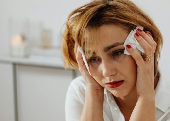 Close-Up Shot of a Sad Woman Holding a Tissue
