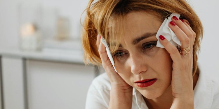 Close-Up Shot of a Sad Woman Holding a Tissue