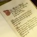 Old opened book with calligraphic inscription