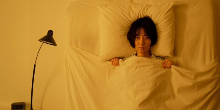 A Woman Lying on the Bed with Blanket
