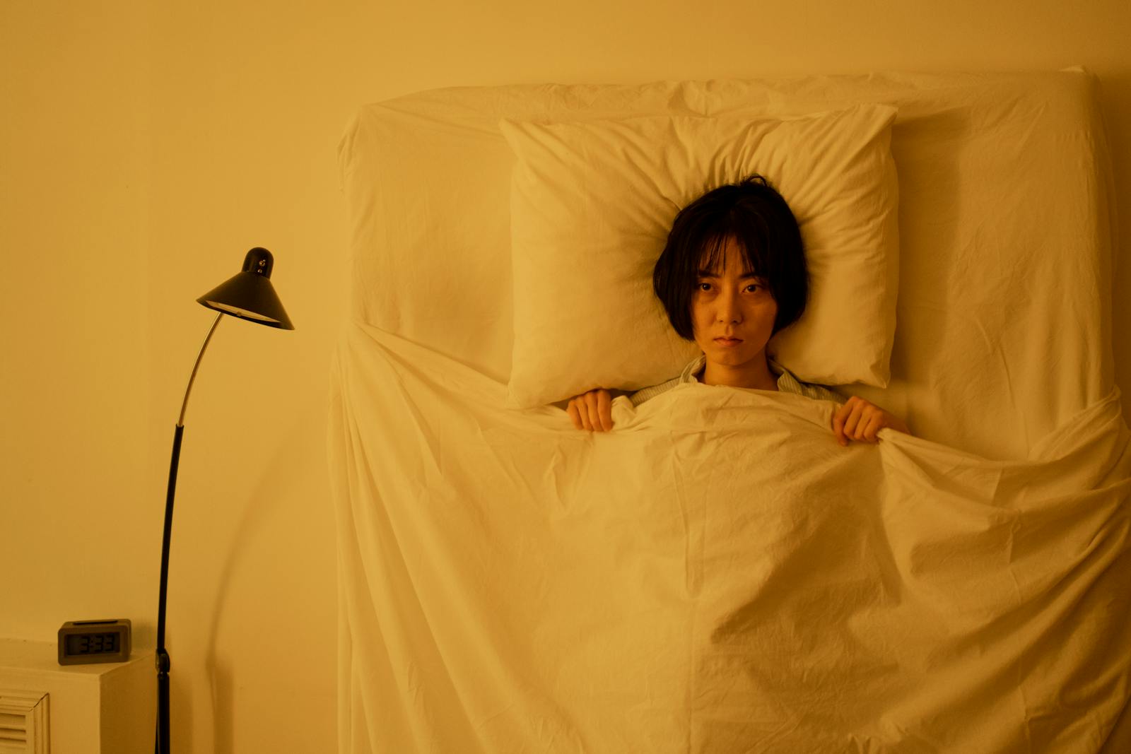 A Woman Lying on the Bed with Blanket