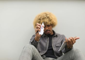 Man Sitting on Floor Having Deep Thoughts on what to Write