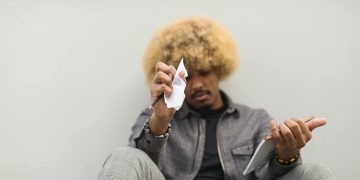 Man Sitting on Floor Having Deep Thoughts on what to Write