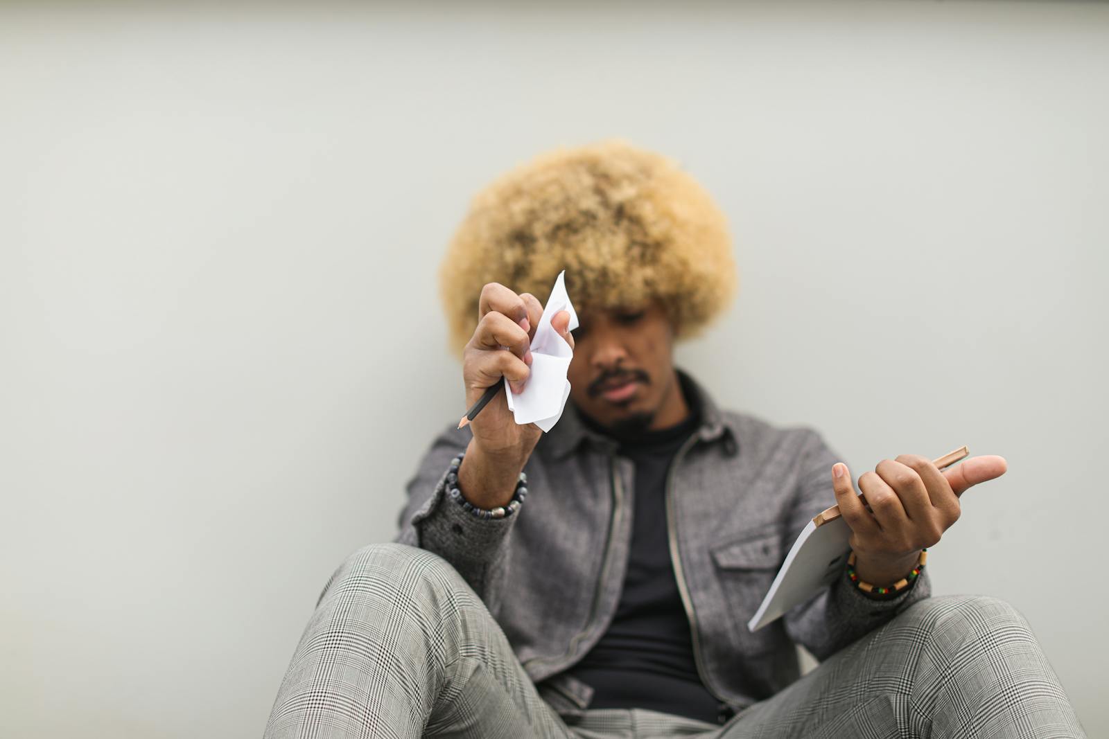 Man Sitting on Floor Having Deep Thoughts on what to Write