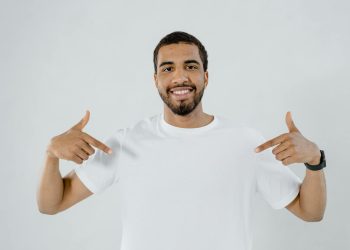 A Bearded Man Pointing at His Plain White Shirt