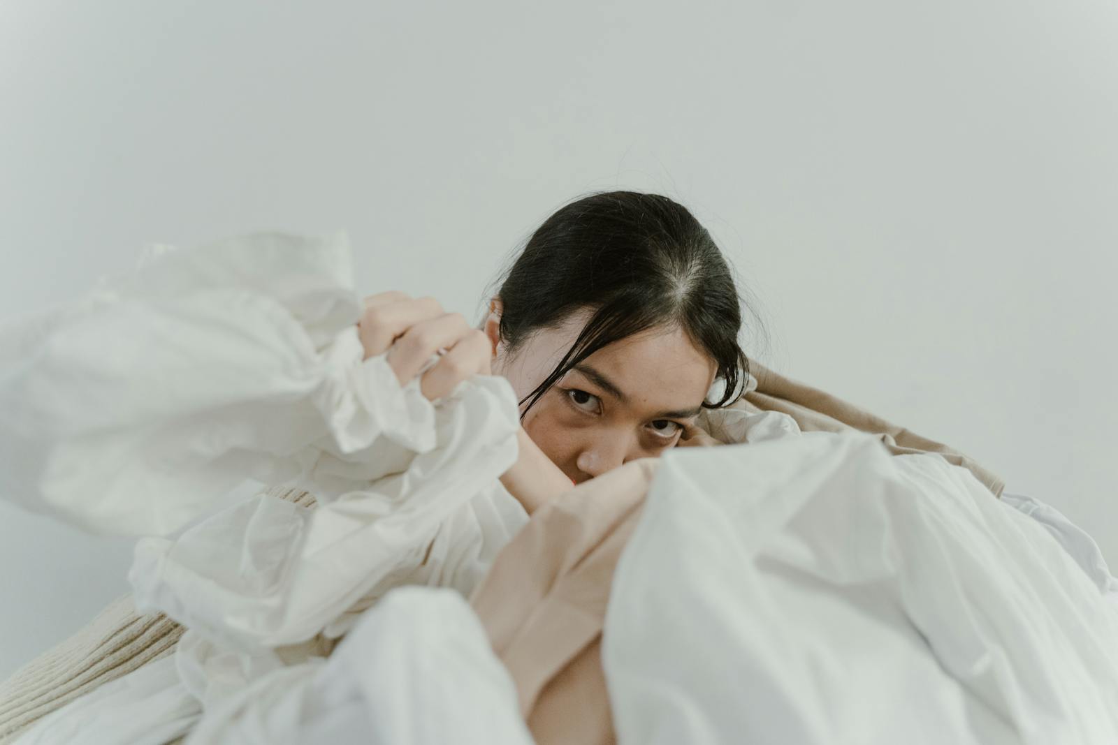 Woman's Hand in a Heap of Fabric