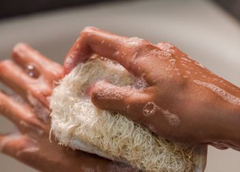 Close-Up Photo of a Person Using a Body Scrub