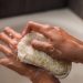 Close-Up Photo of a Person Using a Body Scrub